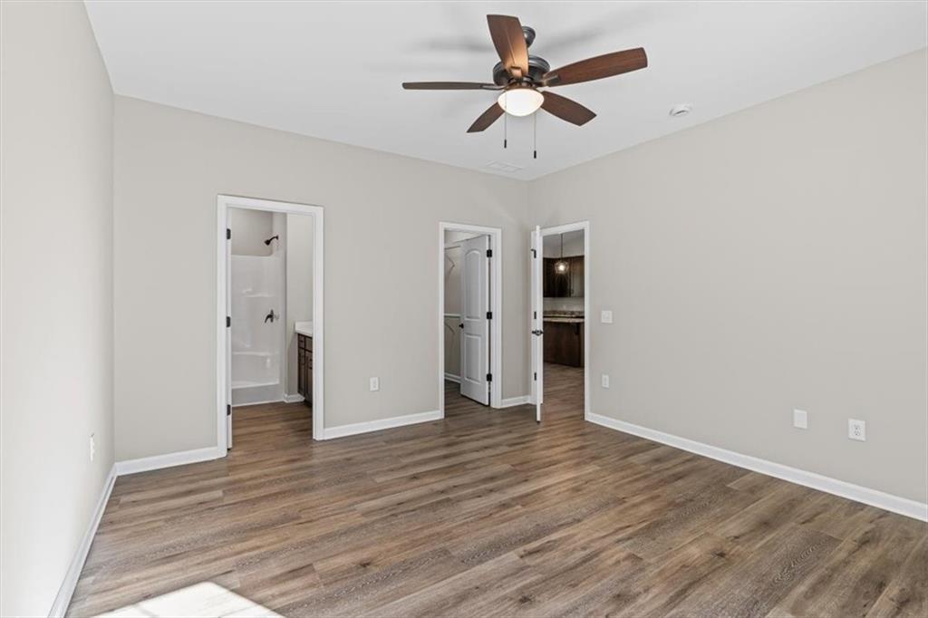 146 Old Brock Road Rockmart, GA 30153 - Photo 21 of 45 an empty room with wooden floor and ceiling fan