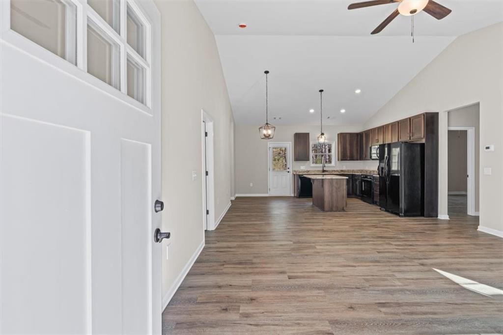 146 Old Brock Road Rockmart, GA 30153 - Photo 8 of 45 a view of a kitchen with stainless steel appliances kitchen island wooden floor and chandelier