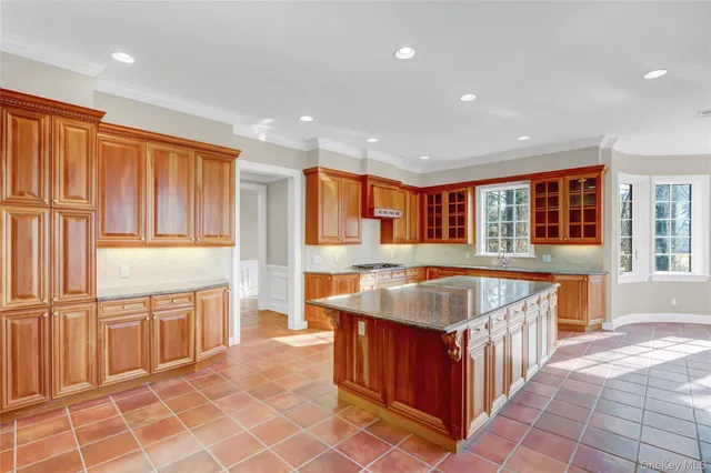 a kitchen with stainless steel appliances granite countertop a sink and a stove