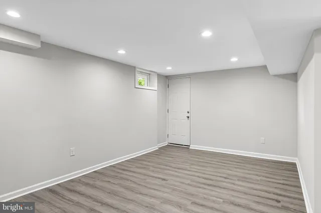 a view of room with wooden floor and natural light