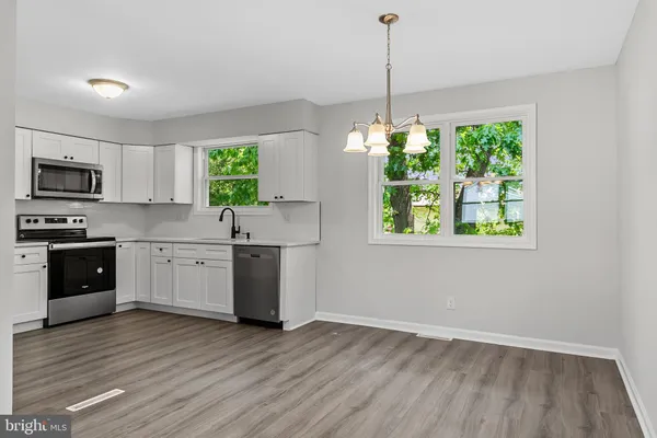 a kitchen with a window a sink and appliances