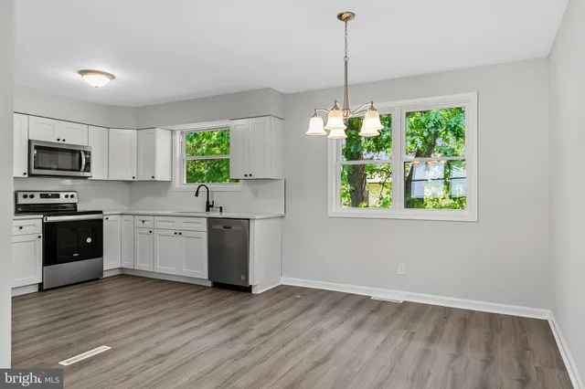 a kitchen with a window a sink and appliances