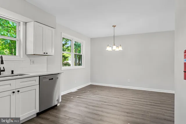a kitchen with cabinets appliances and a window