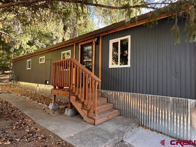 485 Florida Road, Unit D10 Durango, CO 81301 - Photo 2 of 14 a view of a house with a small yard and wooden fence
