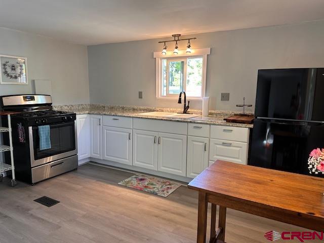 485 Florida Road, Unit D10 Durango, CO 81301 - Photo 8 of 14 a kitchen with a sink cabinets and stainless steel appliances