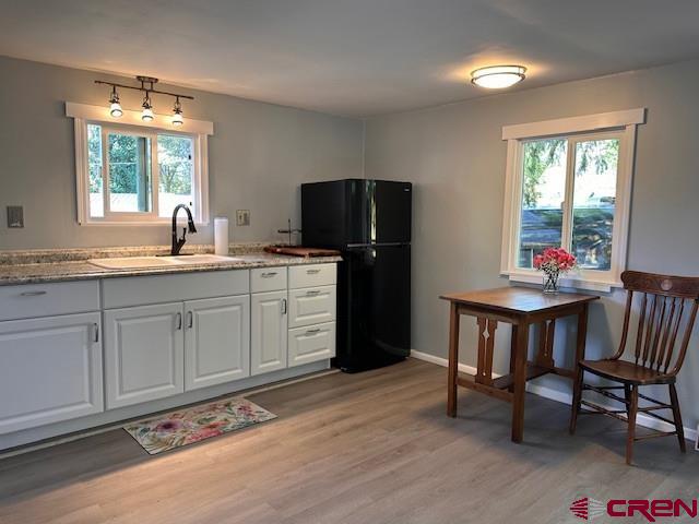 485 Florida Road, Unit D10 Durango, CO 81301 - Photo 9 of 14 a kitchen with a sink cabinets and dining table chair