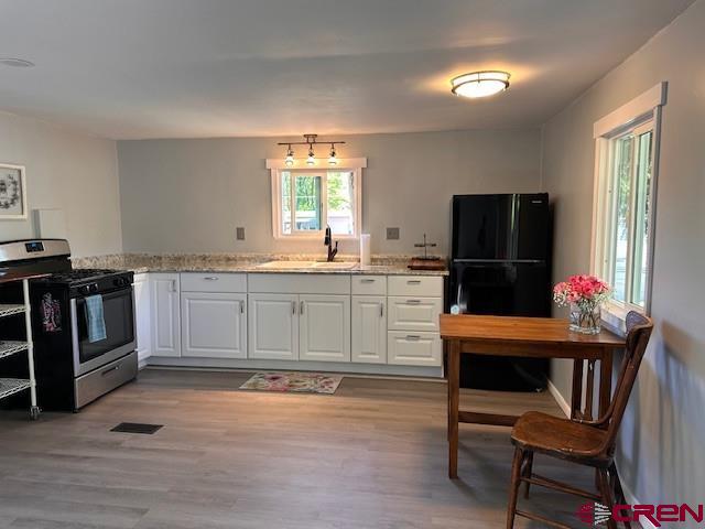 485 Florida Road, Unit D10 Durango, CO 81301 - Photo 10 of 14 a kitchen with stainless steel appliances kitchen island granite countertop a sink cabinets and wooden floor