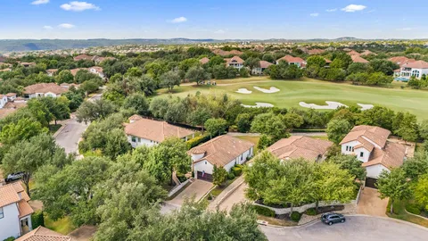 an aerial view of residential houses with outdoor space and street view