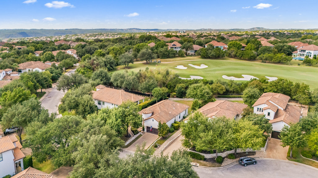 an aerial view of residential houses with outdoor space and street view