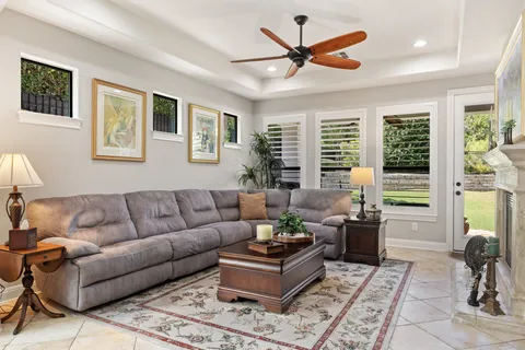a living room with furniture a flat screen tv and a fireplace
