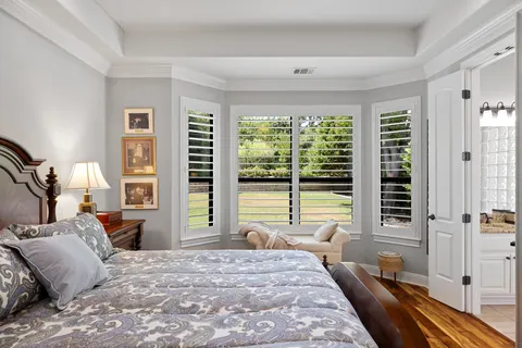 a bathroom with a granite countertop sink a large mirror and a bathtub