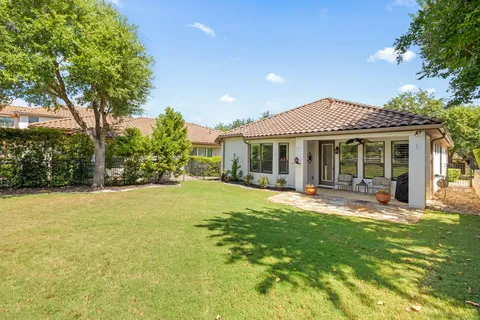 a front view of a house with swimming pool having outdoor seating
