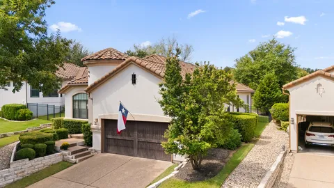 an aerial view of a house with yard swimming pool and green space