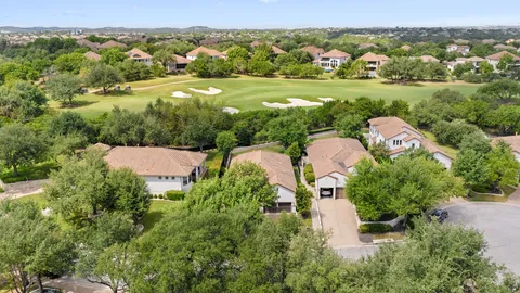 an aerial view of a house with a garden and lake view