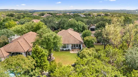 an aerial view of a house with a garden and a car parked