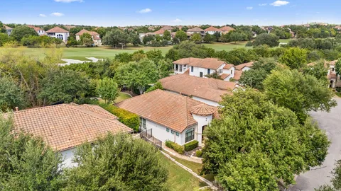 an aerial view of a house with yard and outdoor seating