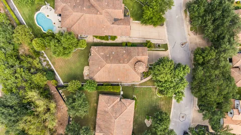 an aerial view of a house with a lake view
