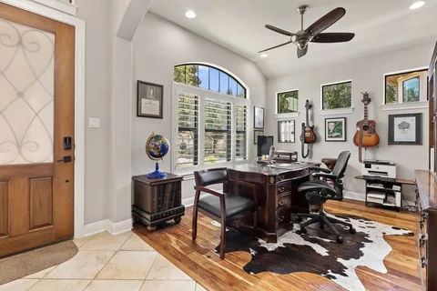 a view of a workspace with furniture and a window