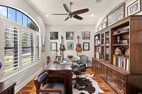 a room with furniture a bookshelf and a window