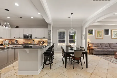 a kitchen with center island table and chairs