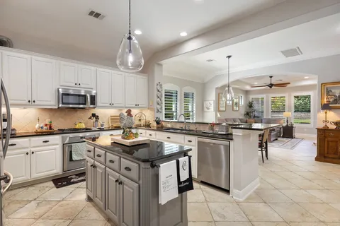 a living room with furniture ceiling fan and a window