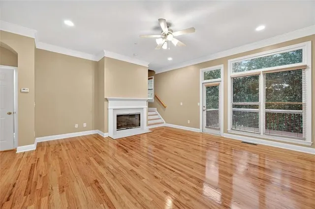 a view of an empty room with a fireplace and a window