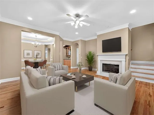 a living room with furniture a fireplace and a flat screen tv