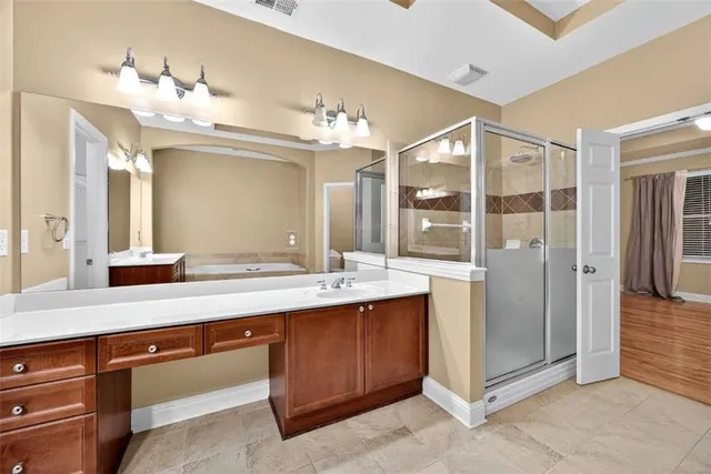 a bathroom with a sink double vanity and a shower