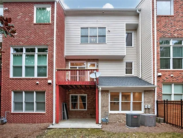 a front view of a house with a yard and outdoor seating