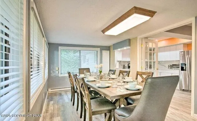 a view of a dining room with furniture and window