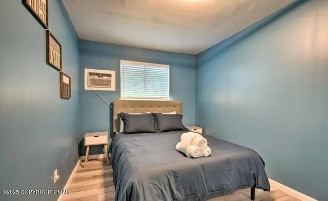 a bedroom with a bed and a window