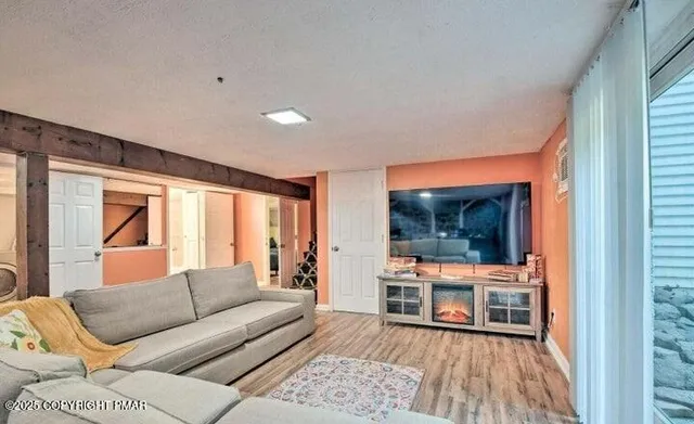 a living room with furniture and a flat screen tv