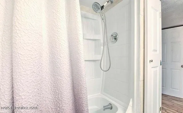 a bathroom with a glass shower door