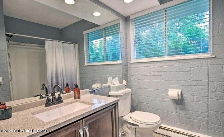 479 Mountain Road Albrightsville, PA 18210 - Photo 25 of 30 a bathroom with a sink a toilet a mirror and a window