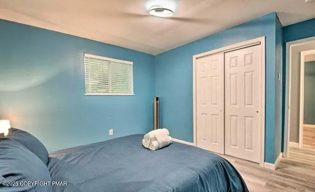 a bedroom with a bed and window