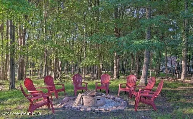 a view of a chairs and table in a backyard