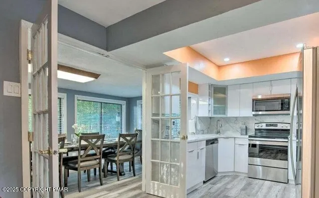 a kitchen with a sink stainless steel appliances and cabinets