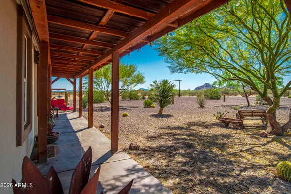 a living room with furniture kitchen and a chandelier