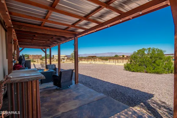 a living room with furniture kitchen and a chandelier