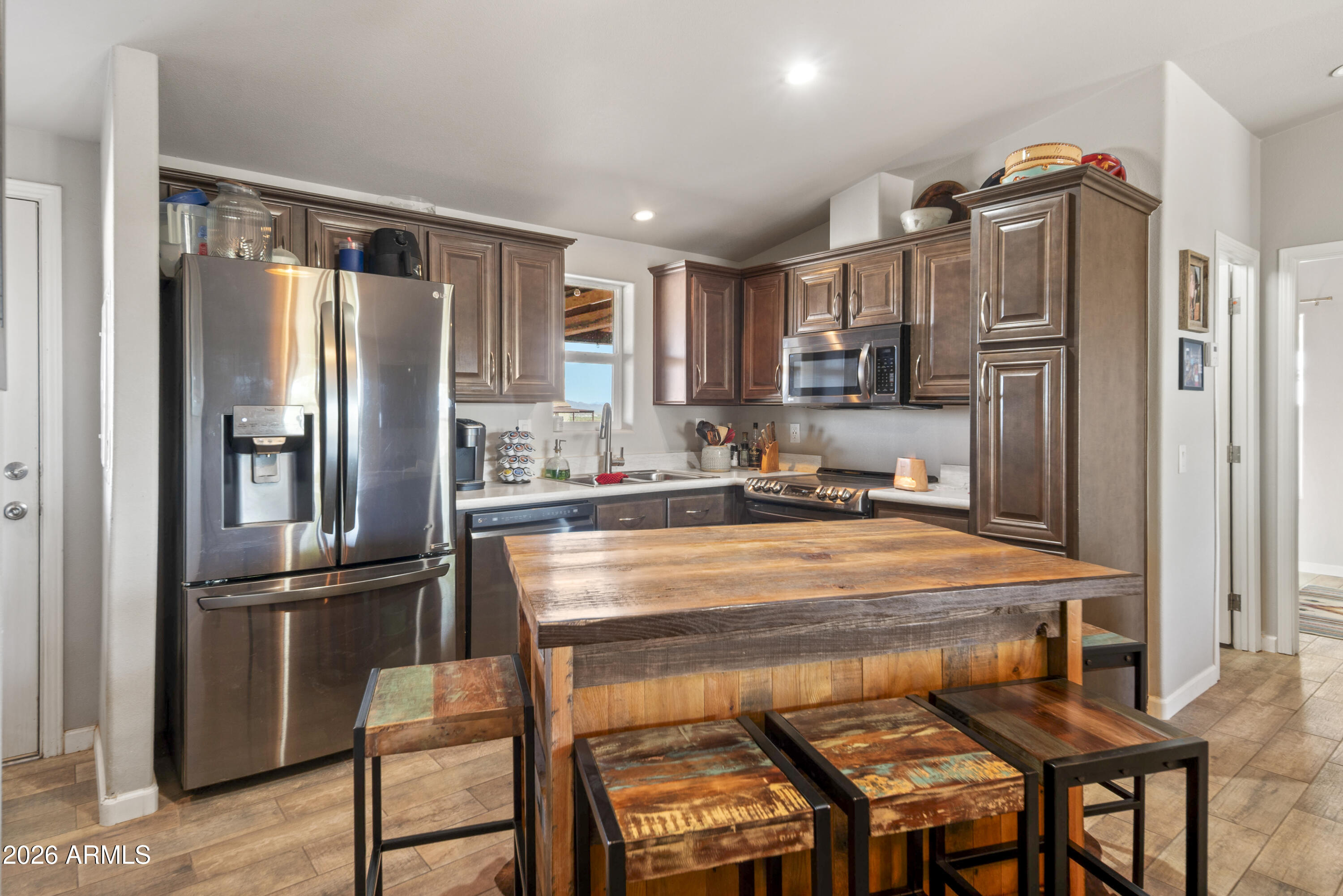 52510 Williams Road Aguila, AZ 85320 - Photo 23 of 62 a kitchen with stainless steel appliances granite countertop a refrigerator and a stove top oven
