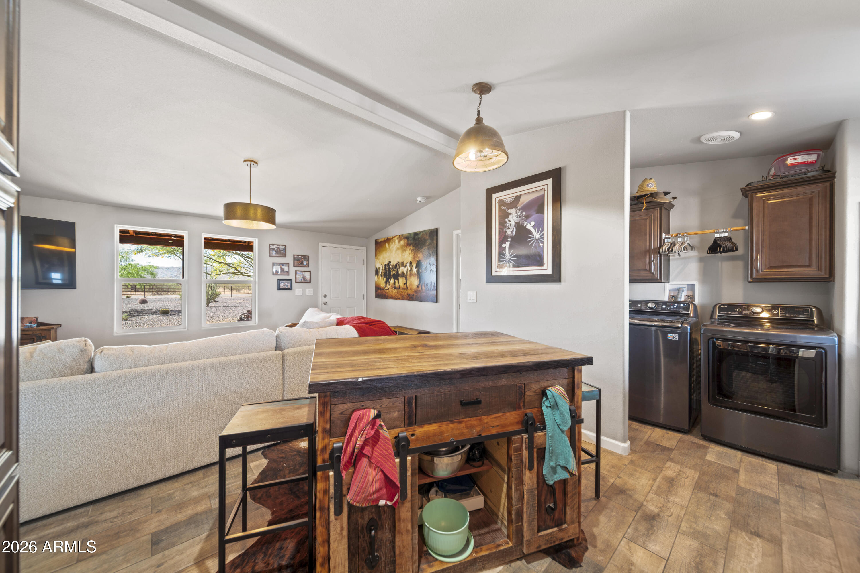 52510 Williams Road Aguila, AZ 85320 - Photo 24 of 62 a kitchen with stainless steel appliances kitchen island granite countertop a table chairs in it and a window