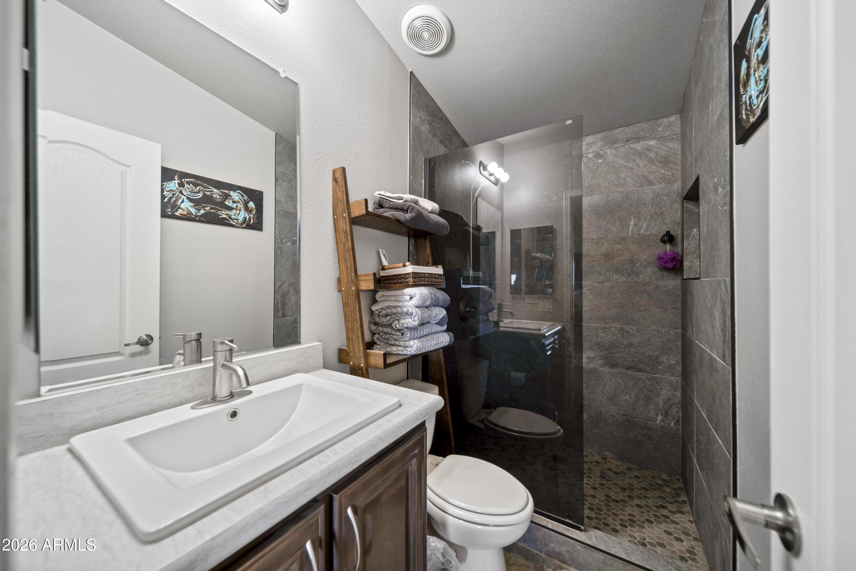 52510 Williams Road Aguila, AZ 85320 - Photo 27 of 62 a bathroom with a sink toilet and shower