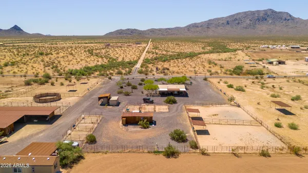 a view of a terrace with furniture and a garden