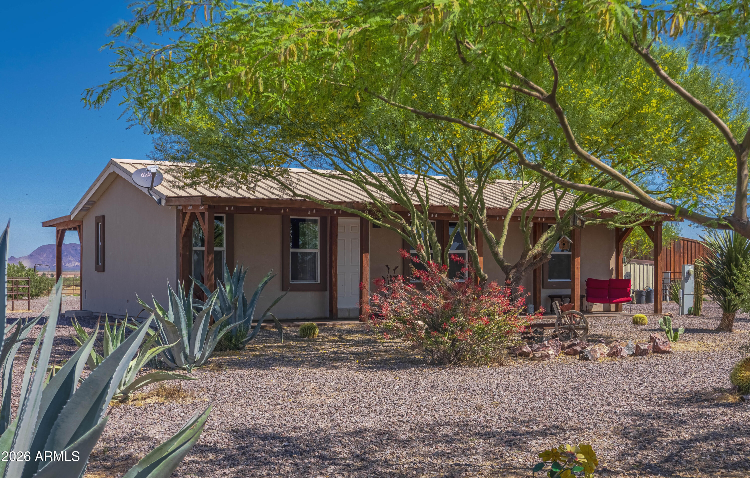 52510 Williams Road Aguila, AZ 85320 - Photo 8 of 62 a view of a house with fountain plants and large trees