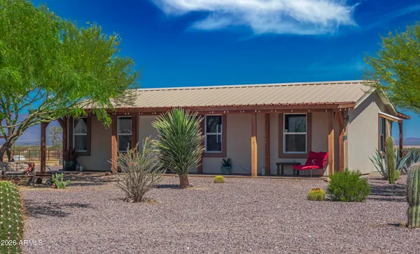 a view of a house with a yard and plants