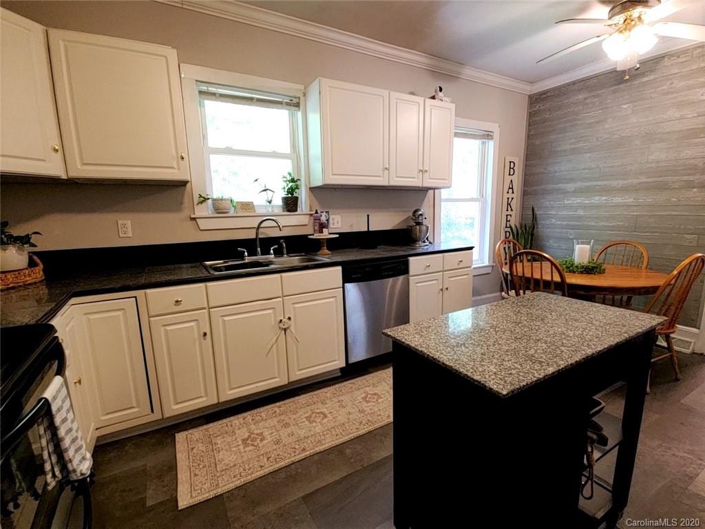 1602 Griffith Road Monroe, NC 28112 - Photo 12 of 45 a kitchen with stainless steel appliances granite countertop a sink stove and cabinets