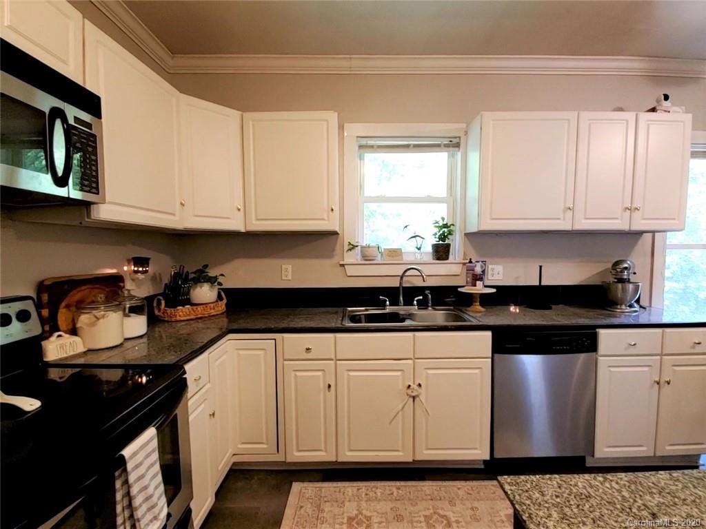 1602 Griffith Road Monroe, NC 28112 - Photo 13 of 45 a kitchen with granite countertop a sink stove and cabinets