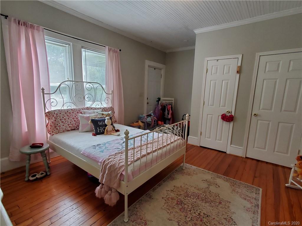 1602 Griffith Road Monroe, NC 28112 - Photo 27 of 45 a bedroom with a bed and wooden floor