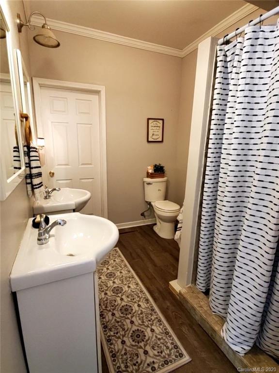 1602 Griffith Road Monroe, NC 28112 - Photo 33 of 45 a bathroom with a sink a toilet and a mirror