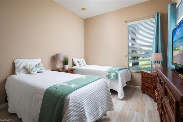 a bedroom with bed chair and a window